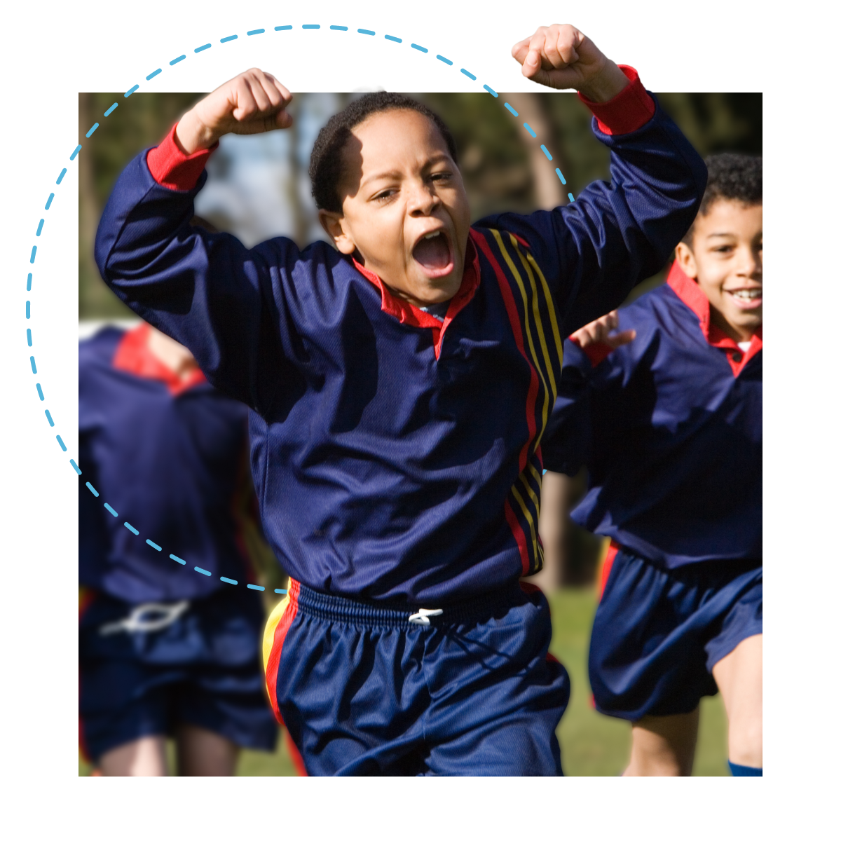 A celebrating youth soccer player running towards the camera