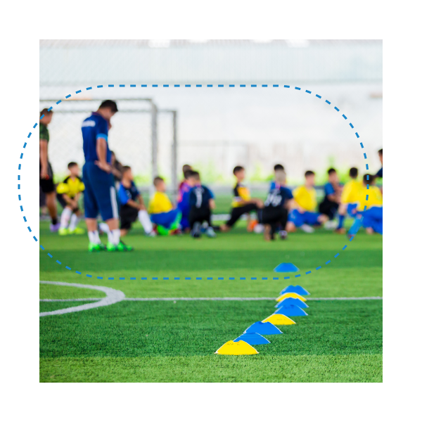 Youth soccer team training on the field with coaches